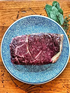 Two inch Wagyu sirloin steak on a blue ceramic plate