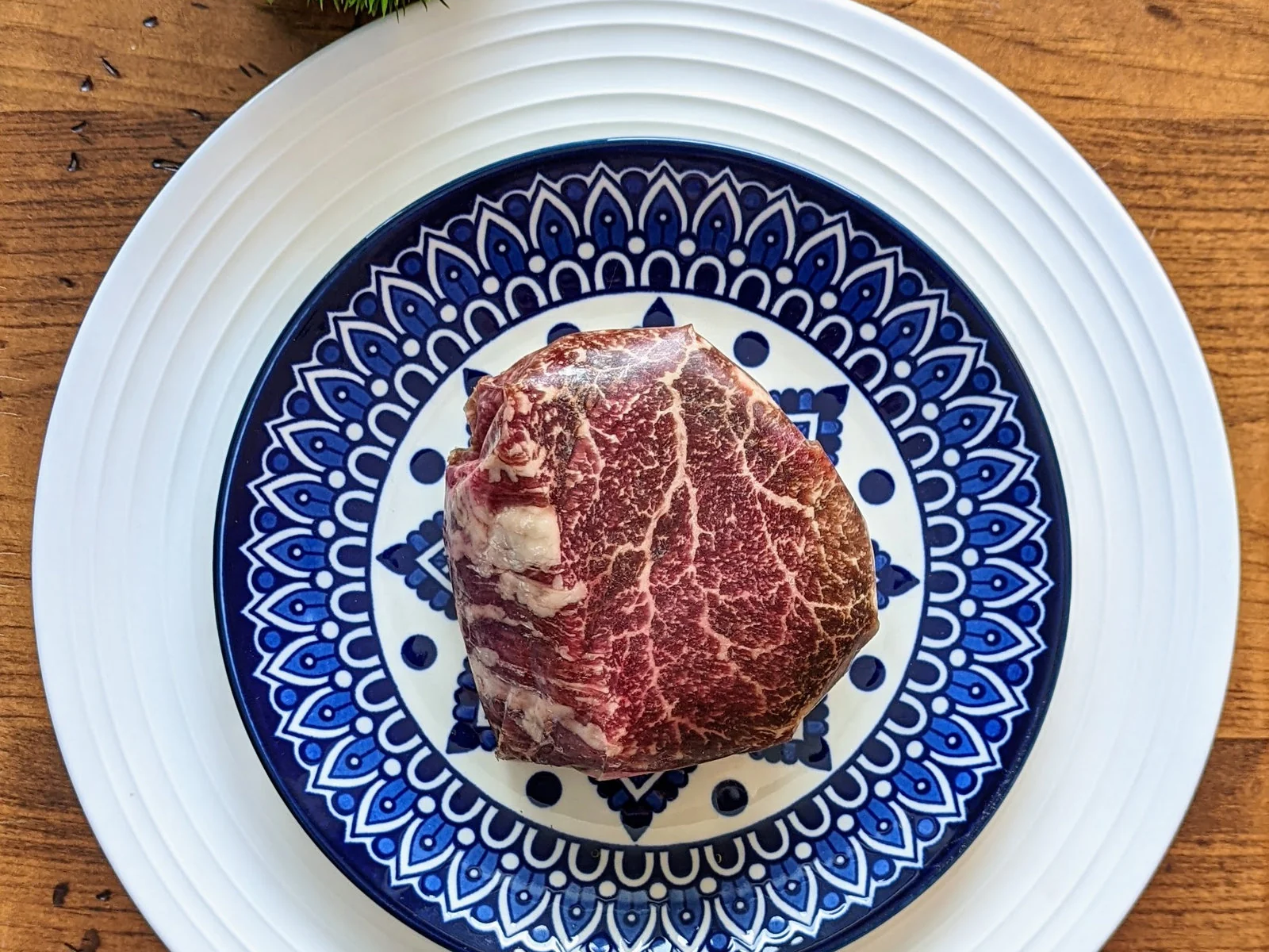 Tenderloin steak plated on blue and white ceramic