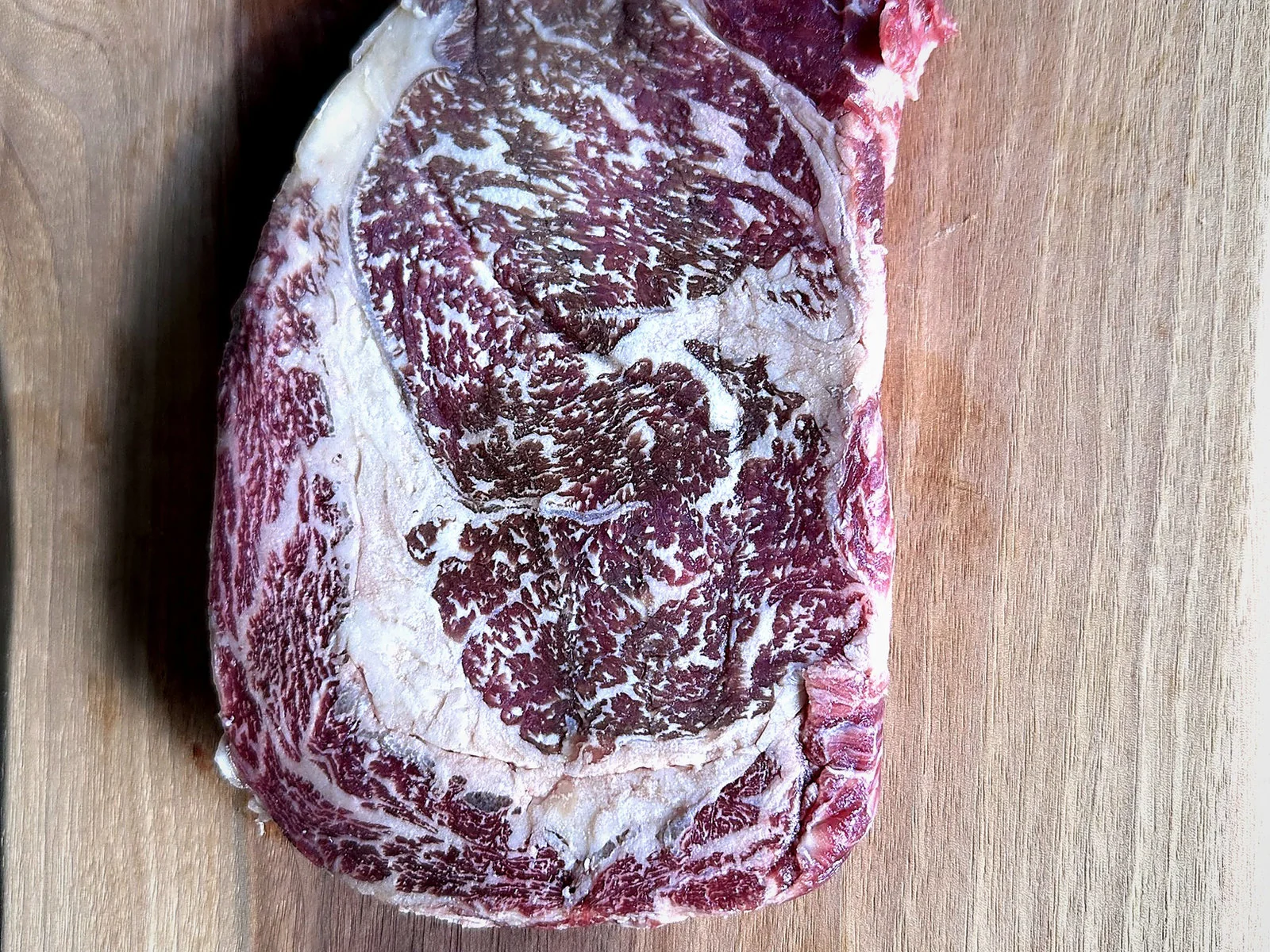 Wagyu rib eye steak showing dense marbling through the eye
