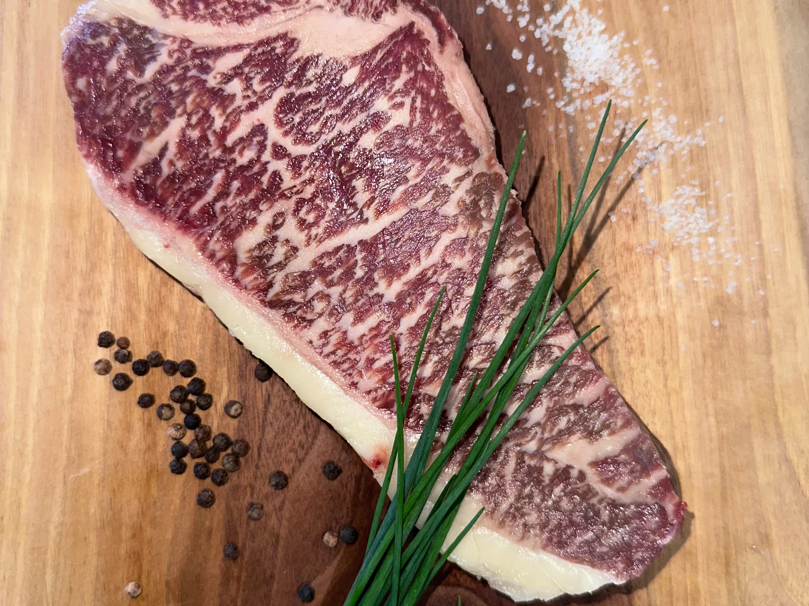 Sixteen ounce Wagyu striploin steak with a thick fat cap